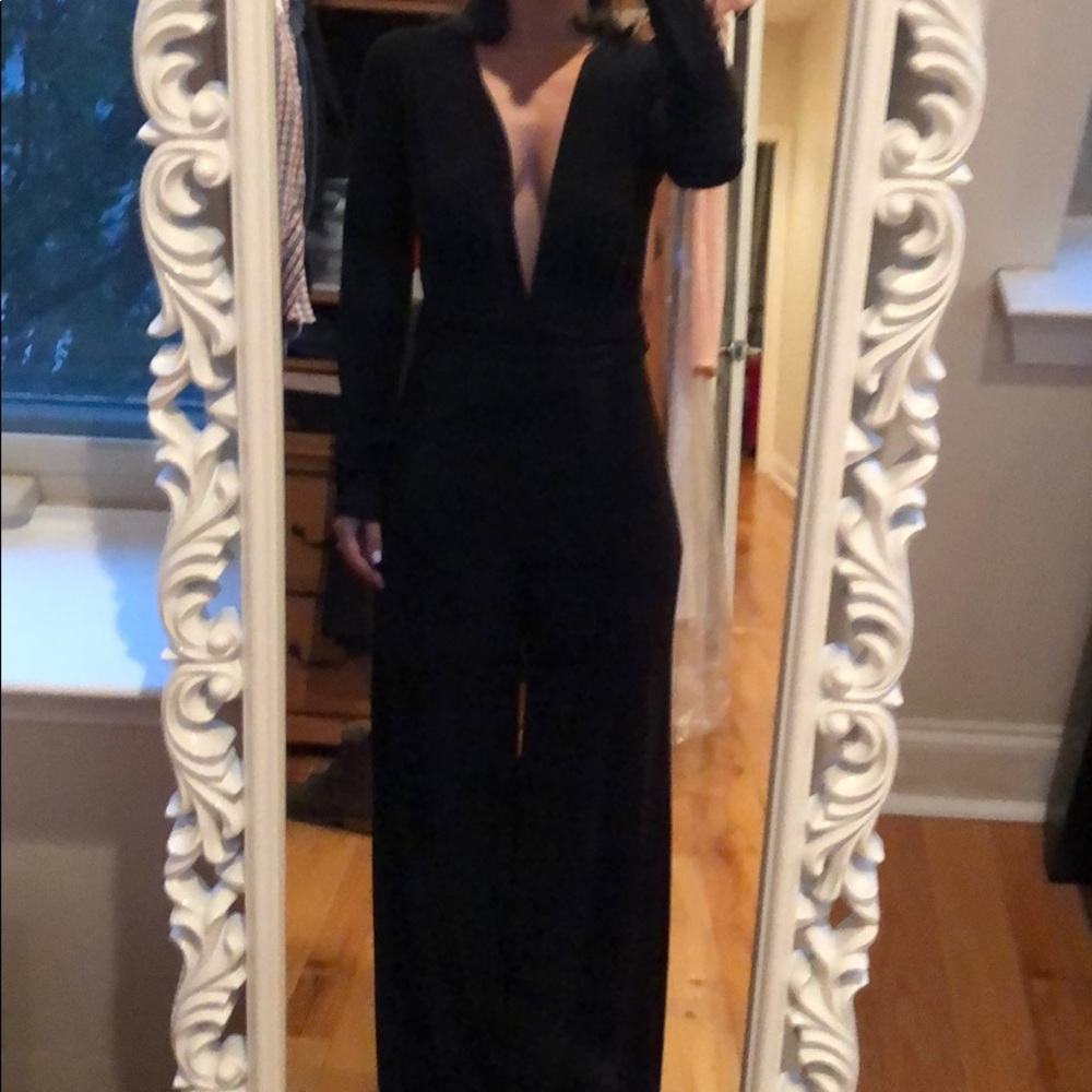 Black long sleeve, deep V jumpsuit.